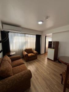 a living room with a couch and a table at Faraona Grand Hotel in Lima