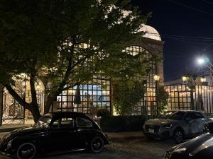 an old car parked in front of a building at night at Hacienda San Patricio in San Miguel de Allende