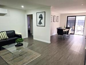 a living room with a couch and a table at No 3 Lakeside in Mulwala +3 photos