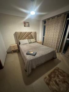 a bedroom with a bed with a book on it at Aura house in Huanchaco
