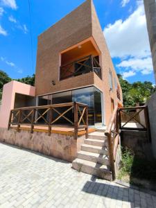 a house with a staircase outside of it at Suíte Recanto dos poetas 07 in Lençóis