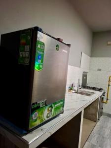 a refrigerator sitting on top of a kitchen counter at Lily's Apartamentos in Cochabamba