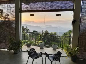 a patio with a table and chairs and a view at Tranquil Edge Villa in Haputale +40 photos