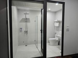 a bathroom with a shower and a toilet at Nhật Tân Hotel Hà Nội - Lê Trọng Tấn in Hanoi
