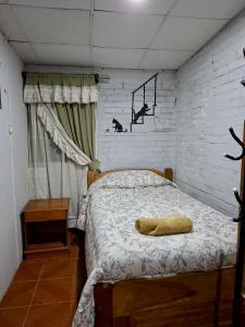 a bedroom with a bed with a pillow on it at Lily's Apartamentos in Cochabamba