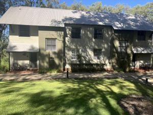 a house with a large yard in front of it at Villa Piccola Casa, Premier 2 Storey Villa, 2 Bedrooms, both with private ensuites, with third toilet on the ground floor in Pokolbin