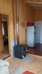 a kitchen with a refrigerator and a stove in a room at Chacra Don Benito Chonchi in Chonchi +40 photos