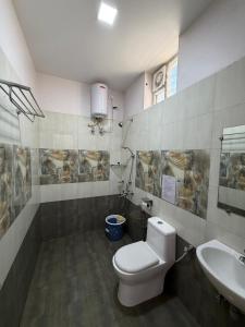 a bathroom with a toilet and a sink at Vanam Holidays in Ooty +149 photos