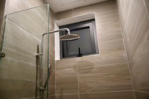 a shower with a glass door and a window at Lumi Home Đà Lạt in Da Thanh +26 photos
