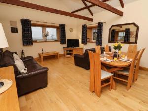 a living room with a table and a couch at Stable D'or in Alnwick