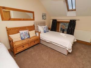 a bedroom with two beds and a mirror at Stable D'or in Alnwick +41 photos