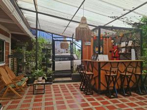 a patio with a bar under a tent at Hotel Cabañas Mar Caribe in Necoclí