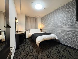 a hotel room with a bed and a window at APA HOTEL Fukushima Ekihigasi in Fukushima