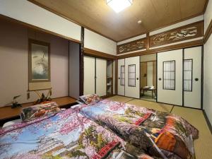 a bedroom with a large bed in a room at Kimono Hotel Himeji 着物宿 in Himeji