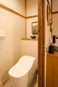 a bathroom with a toilet in a room at Kimono Hotel Himeji 着物宿 in Himeji