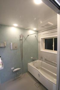 a bathroom with a shower and a tub and a sink at 蝶自来 in Yamaga +6 photos