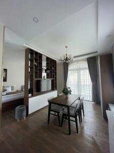 a kitchen and dining room with a table and chairs at Lumi Home Đà Lạt in Da Thanh