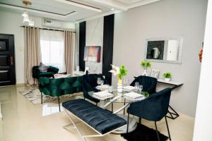 a living room with a dining table and chairs at 2nd street ibex Apartment in Lusaka +26 photos