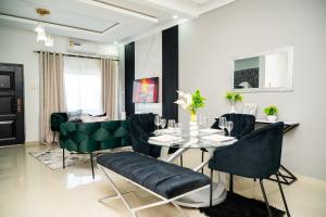 a dining room with a table and green chairs at 2nd street ibex Apartment in Lusaka