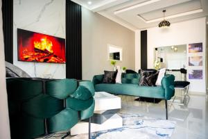 a living room with a green couch and a fireplace at 2nd street ibex Apartment in Lusaka