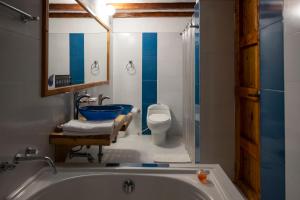 a bathroom with a tub and a toilet and a sink at Hotel Spa Casa de Adobe Villa de Leyva in Villa de Leyva