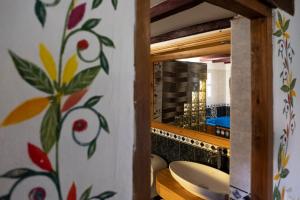 a bathroom with a toilet and a mirror at Hotel Spa Casa de Adobe Villa de Leyva in Villa de Leyva