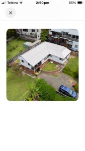 a picture of a large white building with a parking lot at Beach house in Hallidays Point