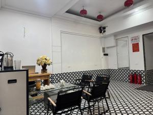 a room with a table and chairs in a room at Hotel Hc Luxury Apartment in Hanoi +18 photos