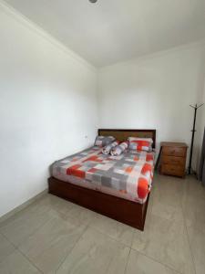 a bedroom with a bed in a white room at Villa Brown Cisarua in Paragajen +20 photos