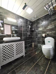 a bathroom with a toilet and a sink at In Spring Country Courtyard in Lijiang in Lijiang