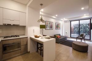 a kitchen and living room with a table and a couch at ZITU 106 in Bogotá