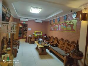 a restaurant with tables and chairs in a room at Bagan Comfort Hotel in Bagan