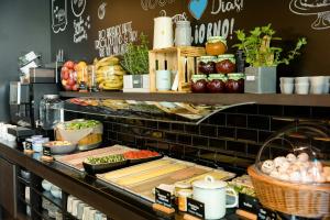 a buffet line with vegetables and other food on display at Motel One Wien-Prater in Vienna