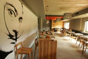 a restaurant with a picture of a woman on the wall at Barcelona Rooms in Mikoszewo