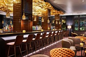 a bar at a restaurant with chairs and tables at Motel One Zürich in Zurich