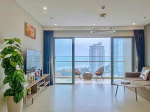 a living room with a couch and a large window at Căn hô The Song Du lịch Biển Tháp Tam Thắng Infinity Pool - Sophia Home in Vung Tau +149 photos