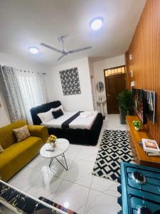 a living room with a couch and a table at Mo Homes studio in Mombasa