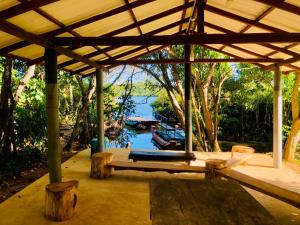 a pavilion with a view of a river with boats in it at Thotupola Villa - Mirissa in Mirissa