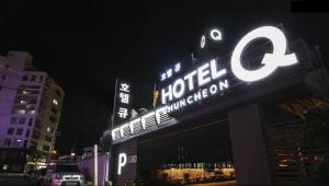 a sign on top of a hotel at night at Hotel Q Chuncheon in Chuncheon