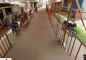 an empty hallway in a building with a fence at Mahadev Guest House in Deoghar +29 photos