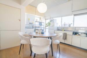 a dining room with a table and chairs in a kitchen at REKADO ROOM Kengun in Kumamoto