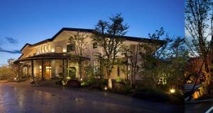 a large white house with trees in front of it at REKADO ROOM Kengun in Kumamoto