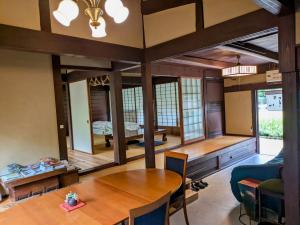 a living room with a table and a couch at 古民家のこのこ in Tanabe