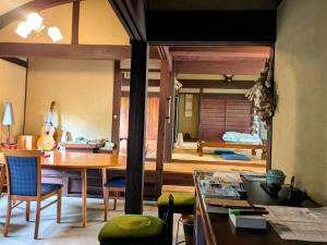a living room with a table and a dining room at 古民家のこのこ in Tanabe
