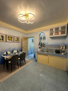 a kitchen and dining room with a table and a dining room gmaxwell gmaxwell at Carmela Haven Inn in Baler