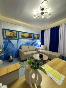 a living room with a couch and a table at Carmela Haven Inn in Baler +92 photos