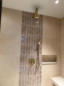 a shower with a shower head in a bathroom at Anket De' River Mui Ne resort in Mui Ne