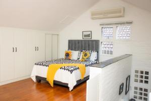 a bedroom with a bed in a white room at Black n Whyt Villa in Kloof +41 photos