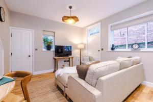 a living room with a couch and a table at Cathedral Mews - Close to the Cathedral in Ripon +15 photos
