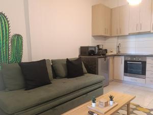 a living room with a couch and a kitchen at Molly Downtown Thessaloniki in Thessaloniki